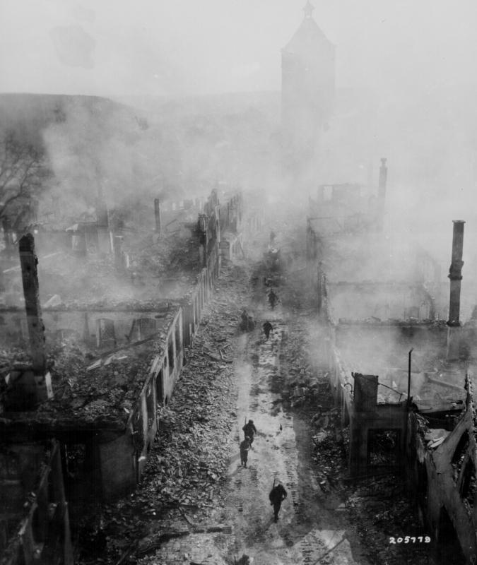 255 Infantry Regiment move down a street in Waldenburg